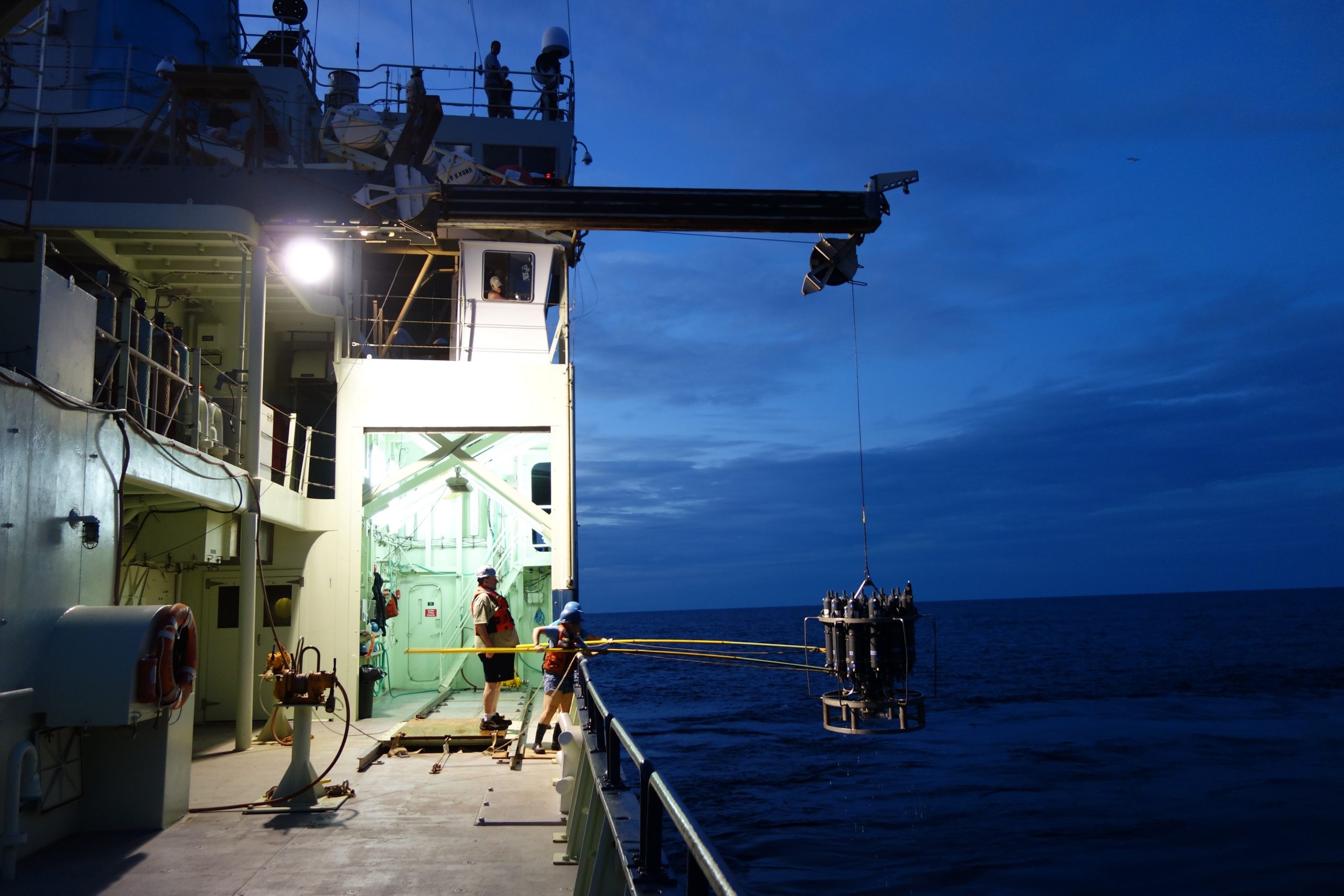 Two students help the marine technician recover the rosette during night sampling on a cruise to the South Atlantic. Image credit: Elizabeth Kujawinski, WHOI. 