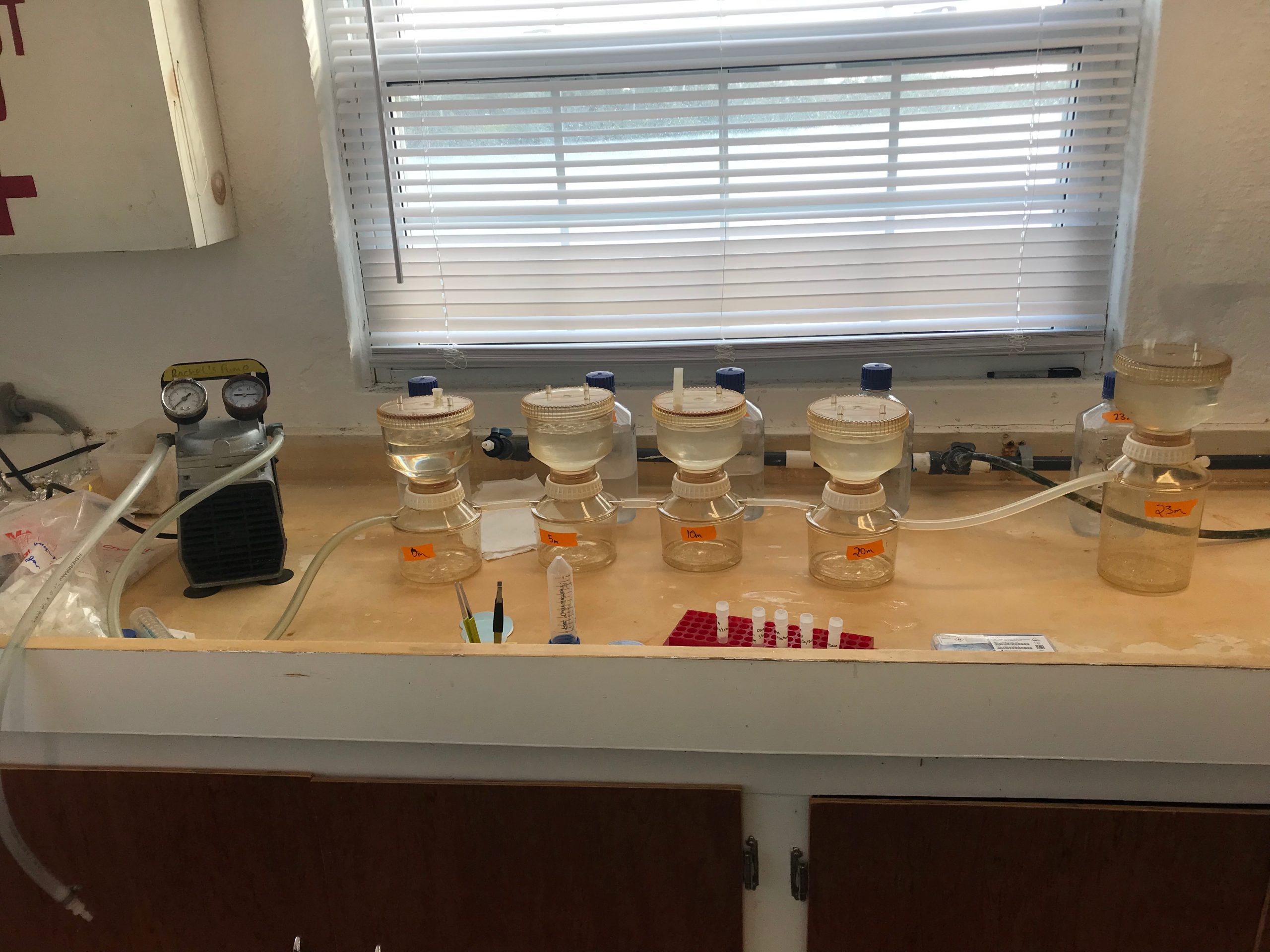 Four filter towers arranged on a bench in a lab at Bermuda Institute of Ocean Sciences.