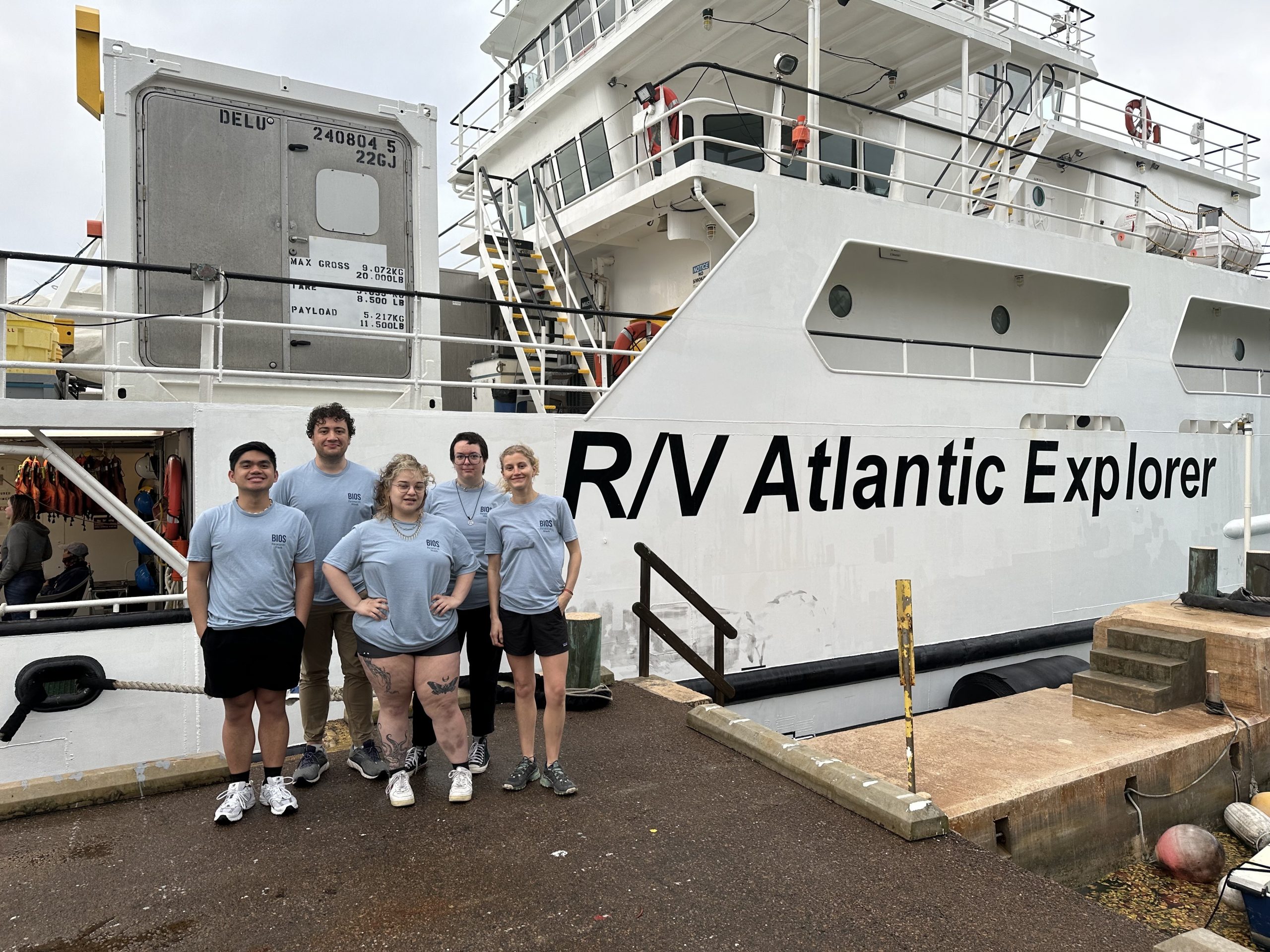 Five individuals attending BIOS Research Week stand in front of the R/V Atlantic Explorer in Bermuda.